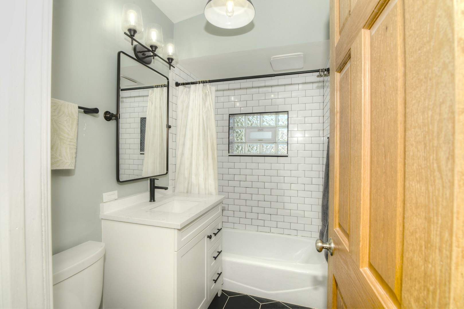 305 Maple Street Glen Ellyn, IL 60137 - Photo 22 of 28 a bathroom with a shower toilet sink and mirror