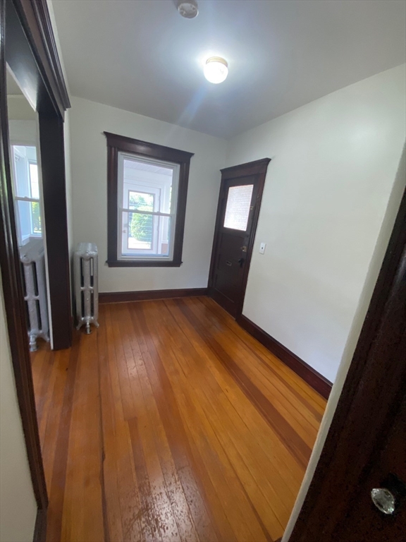 14 Welton Road Boston, MA 02132 - Photo 9 of 31 wooden floor in an empty room with a window