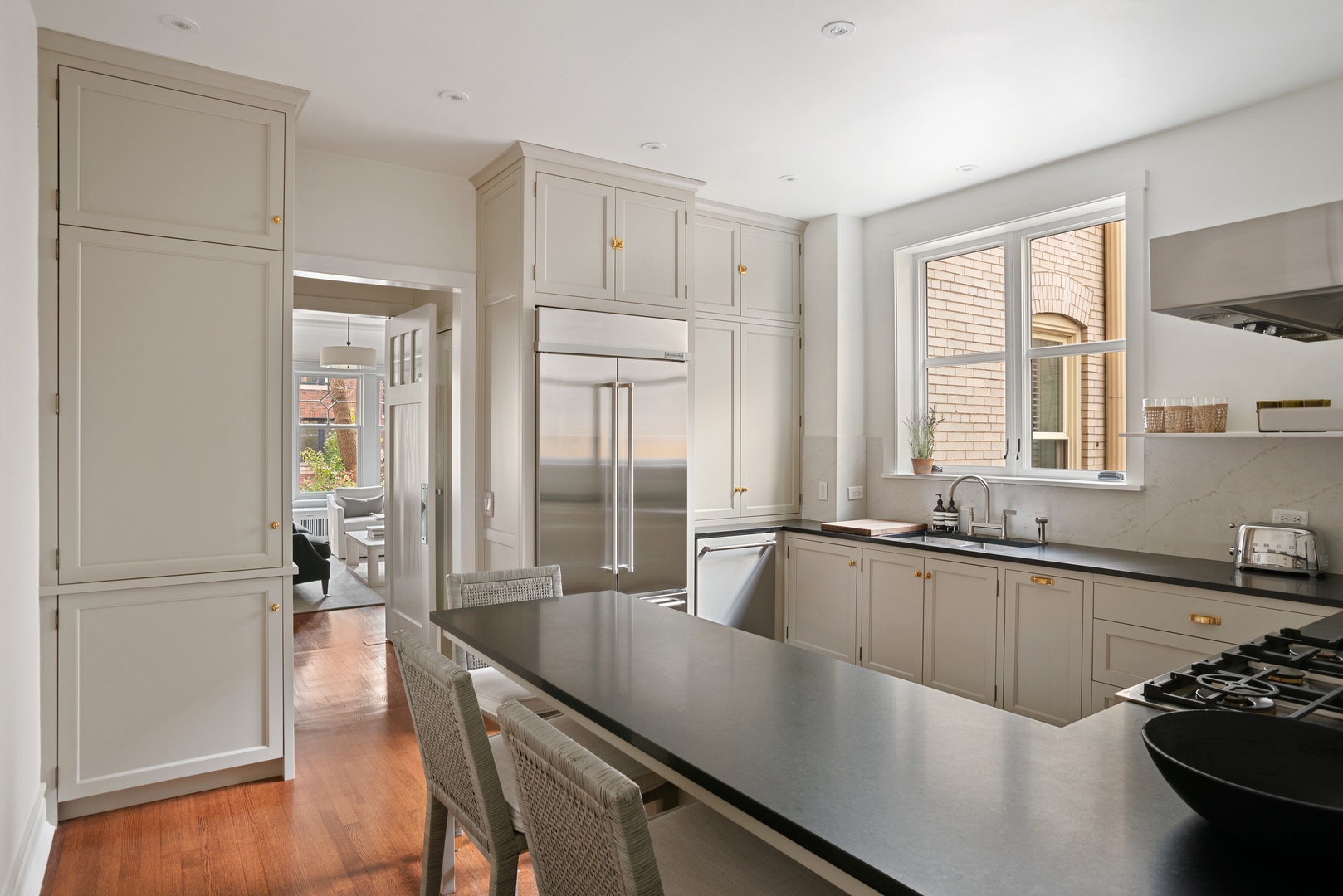 322 West Belden Avenue, Unit 1W Chicago, IL 60614 - Photo 12 of 24 a large kitchen with kitchen island a large window a sink and stainless steel appliances
