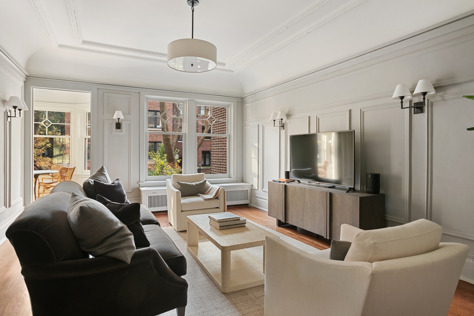 322 West Belden Avenue, Unit 1W Chicago, IL 60614 - Photo 8 of 24 a living room with furniture a large window and a flat screen tv