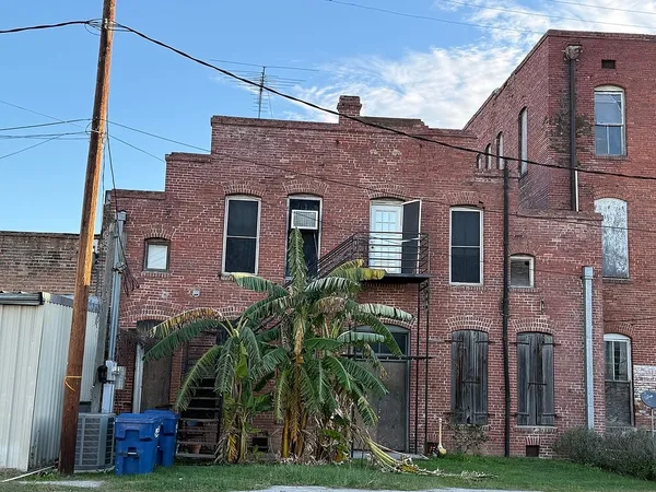 a view of a brick building next to a yard