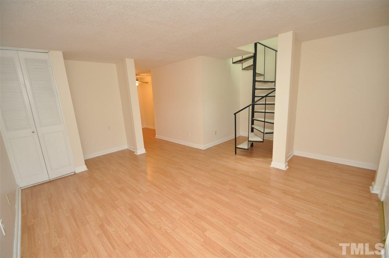 4341 Lake Ridge Drive Raleigh, NC 27604 - Photo 4 of 16 a view of empty room with stairs and wooden floor