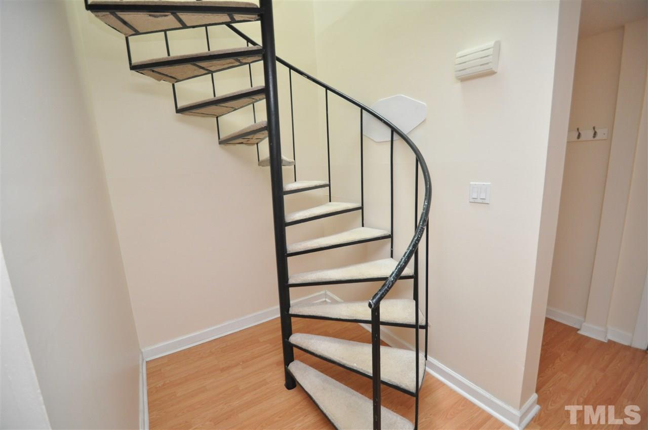 4341 Lake Ridge Drive Raleigh, NC 27604 - Photo 5 of 16 a view of staircase with a metal railing and a potted plant