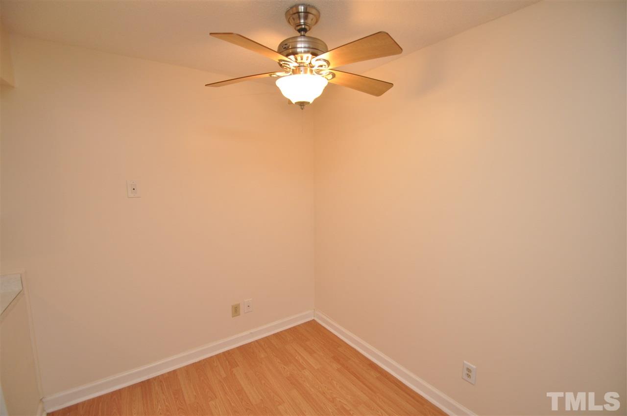 4341 Lake Ridge Drive Raleigh, NC 27604 - Photo 6 of 16 a view of a small space with wooden floor and a ceiling fan