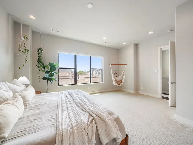 a bedroom with a large bed and chandelier