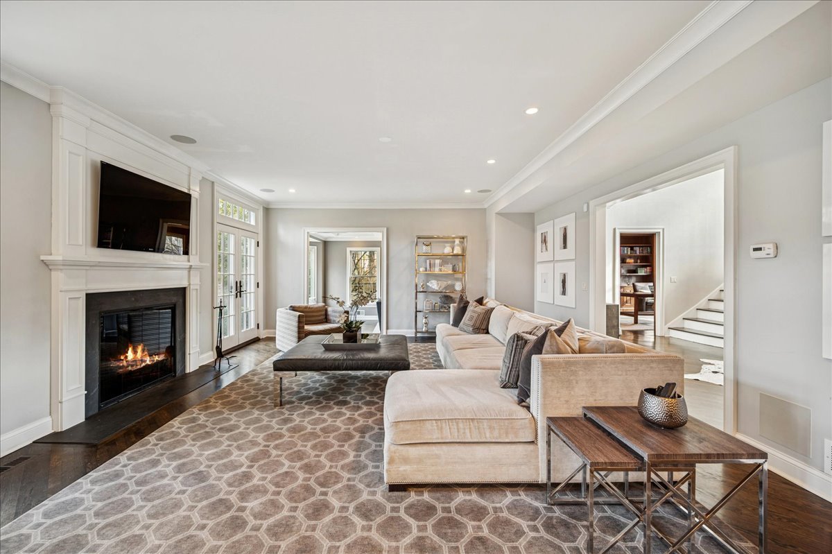 Undisclosed Address Winnetka, IL 60093 - Photo 11 of 55 a living room with furniture a flat screen tv and a fireplace