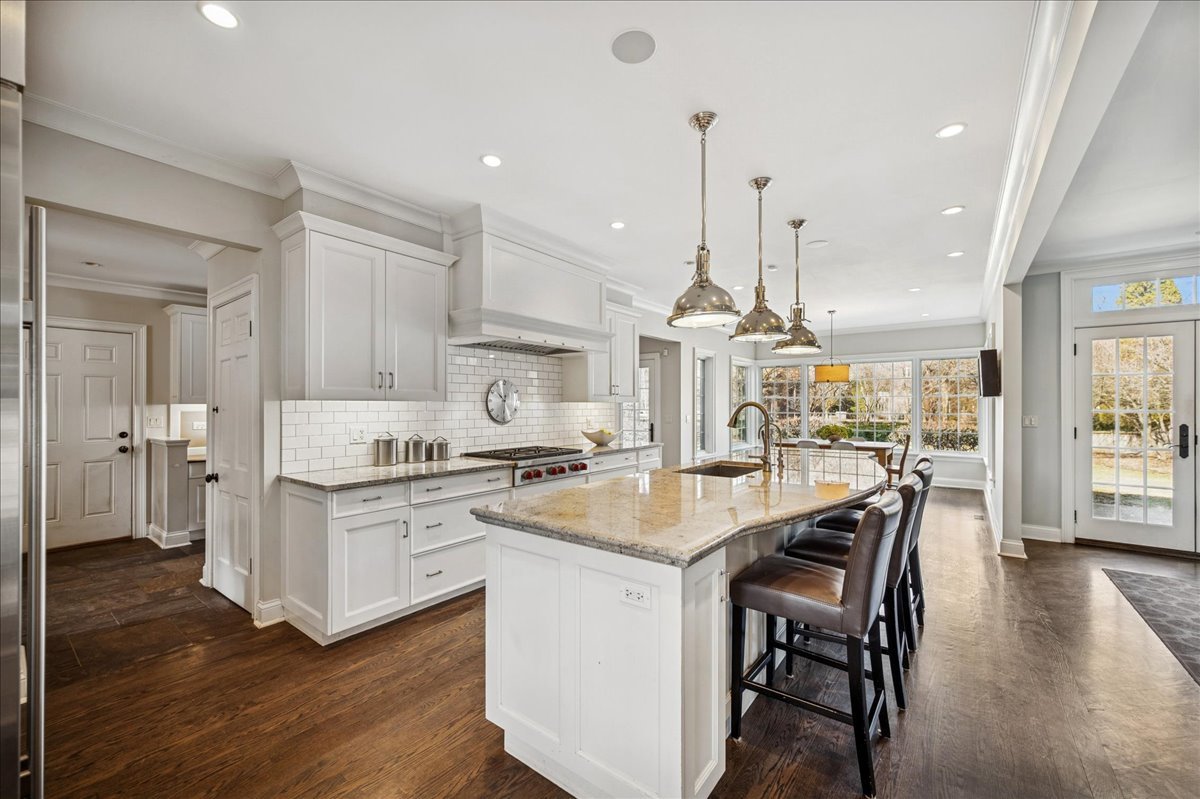 Undisclosed Address Winnetka, IL 60093 - Photo 14 of 55 a kitchen with stainless steel appliances granite countertop a stove top oven a refrigerator a sink and a dining table with wooden floor