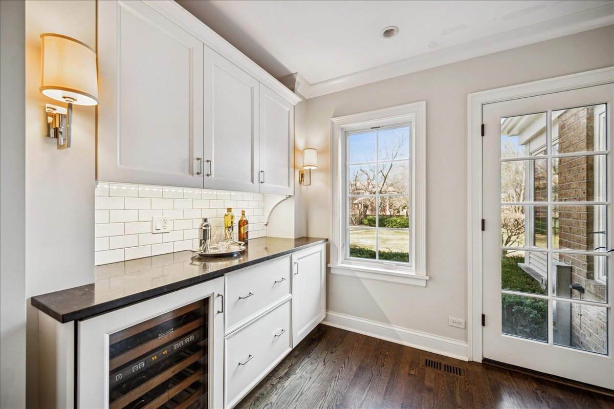 Undisclosed Address Winnetka, IL 60093 - Photo 18 of 55 a kitchen with granite countertop wooden cabinets a sink and a window