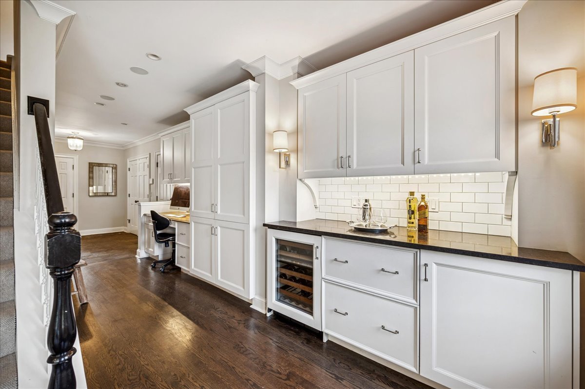 Undisclosed Address Winnetka, IL 60093 - Photo 20 of 55 a kitchen with granite countertop white cabinets and white appliances