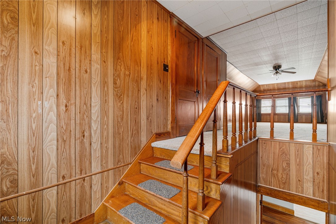 1640 Old Delaware Road Mount Vernon, OH 43050 - Photo 30 of 49 Stairway featuring wood walls and ceiling fan