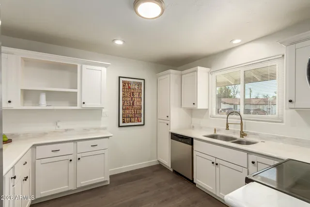 a kitchen with a sink cabinets and window