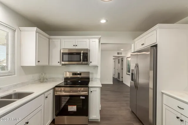 a kitchen with a refrigerator stove and sink