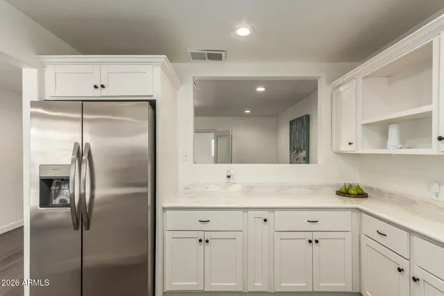 a kitchen with cabinets and stainless steel appliances
