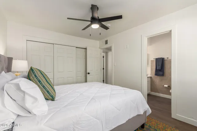 a bedroom with a bed and a chandelier