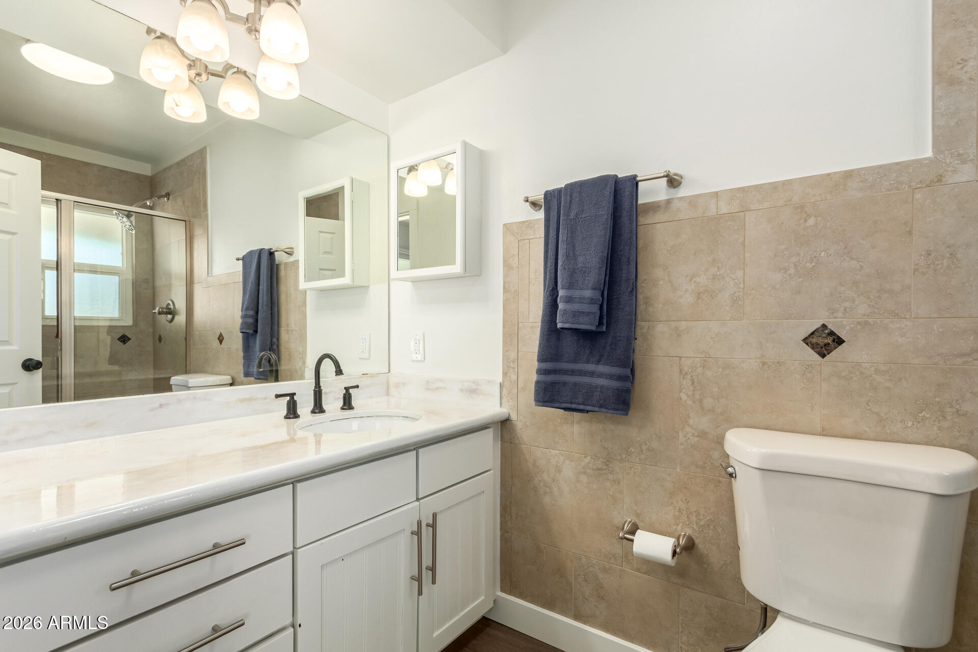 7819 North 17th Avenue Phoenix, AZ 85021 - Photo 19 of 31 a bathroom with a sink a toilet and a large mirror