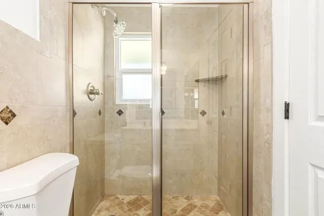 a bathroom with a shower and toilet