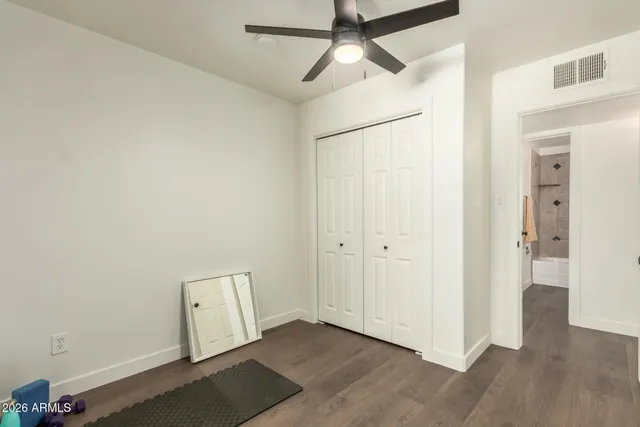 a view of empty room with wooden floor