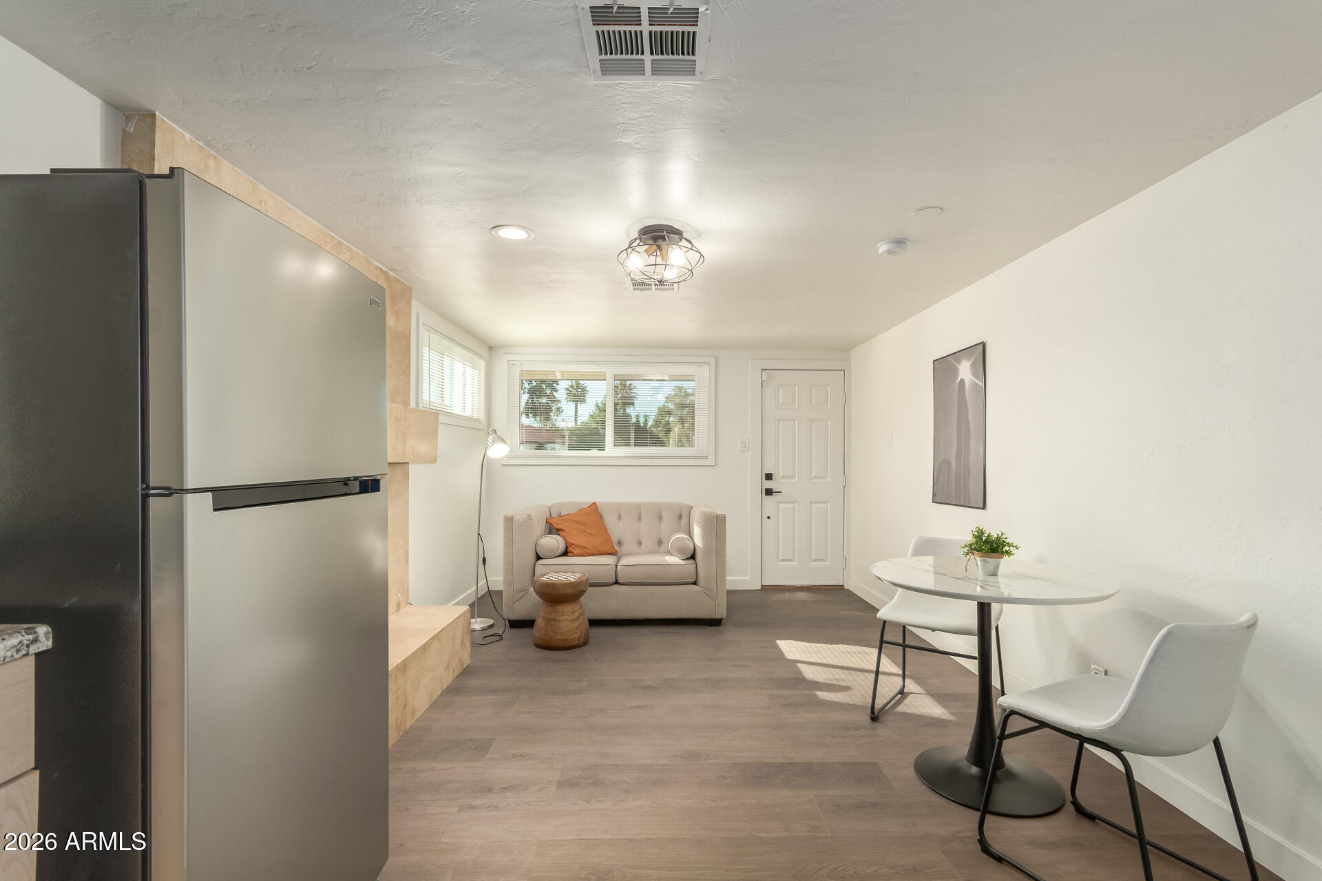 7819 North 17th Avenue Phoenix, AZ 85021 - Photo 26 of 31 a living room with furniture and a refrigerator
