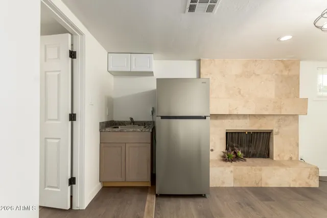 a kitchen with cabinets and a refrigerator