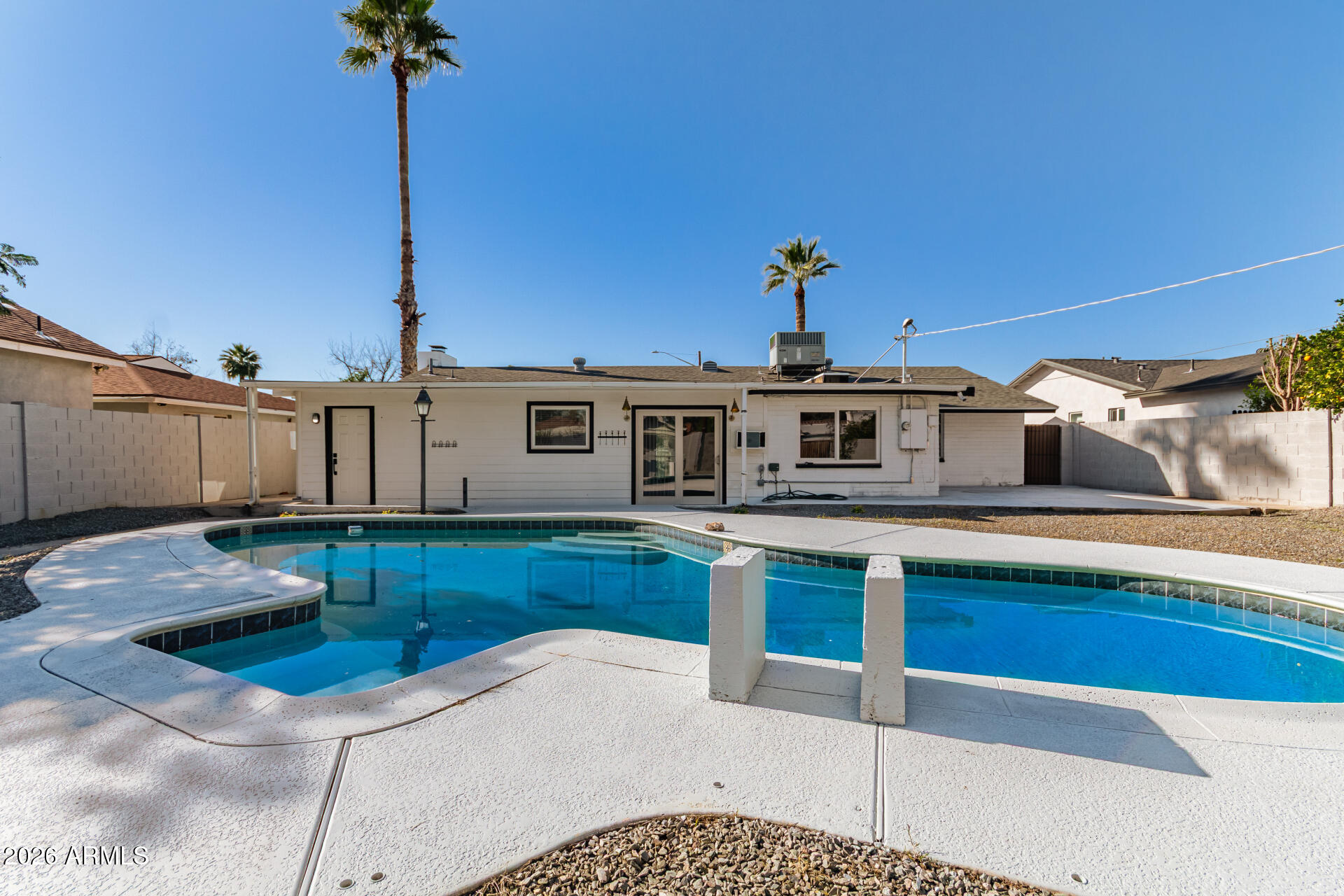 7819 North 17th Avenue Phoenix, AZ 85021 - Photo 5 of 31 a kitchen with stainless steel appliances kitchen island granite countertop a sink and cabinets