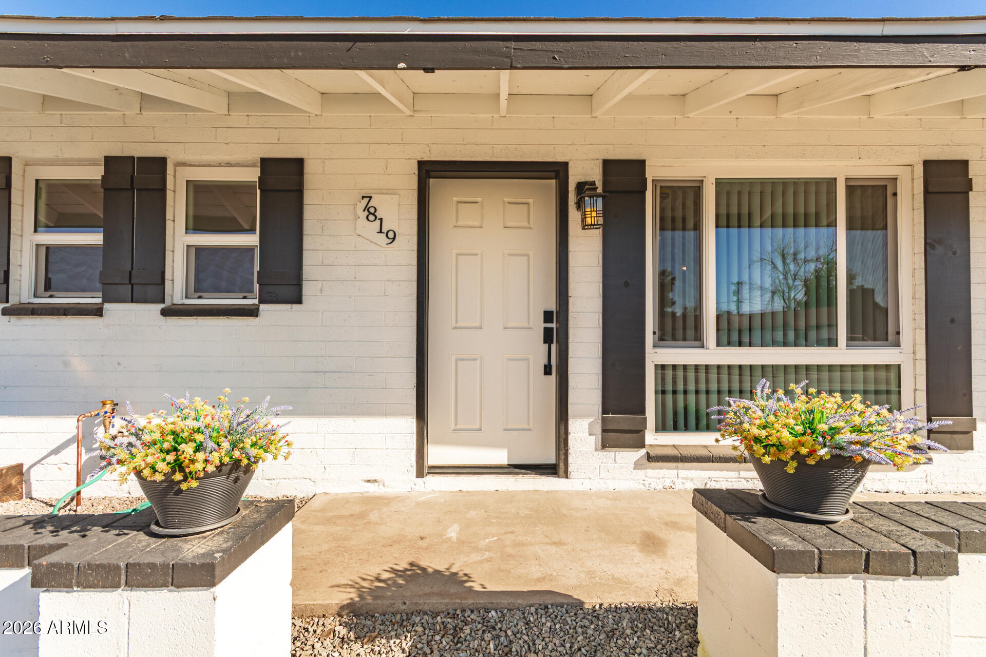 7819 North 17th Avenue Phoenix, AZ 85021 - Photo 7 of 31 a front view of a house with a potted plant