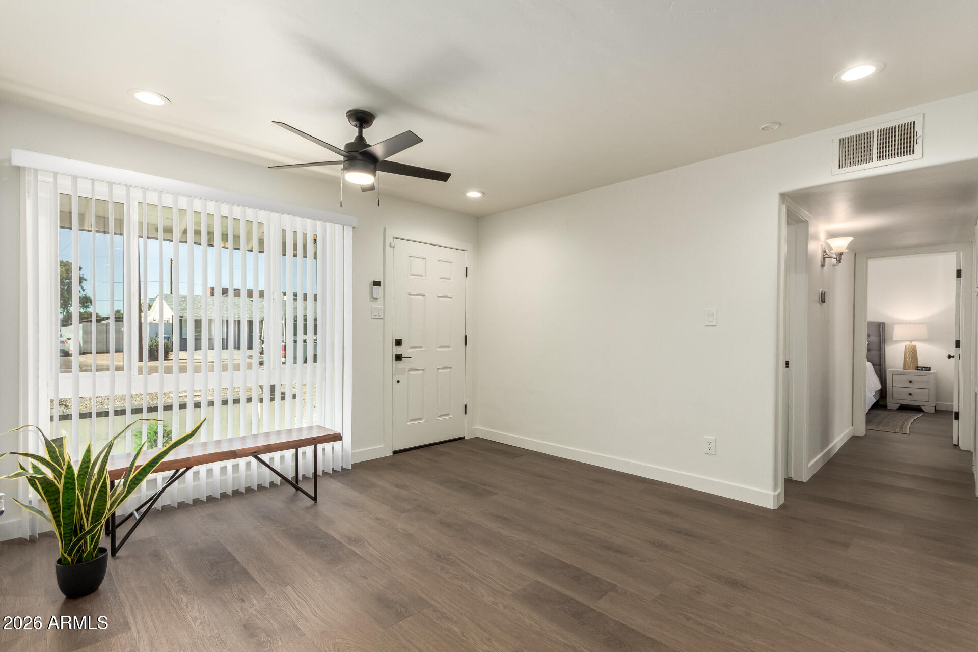 7819 North 17th Avenue Phoenix, AZ 85021 - Photo 9 of 31 an empty room with wooden floor and windows