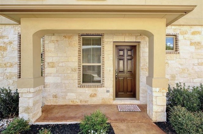 14001 Avery Ranch Boulevard, Unit 801 Austin, TX 78717 - Photo 2 of 26 A welcoming stone facade with a paneled entry door and covered porch offers exceptional curb appeal.