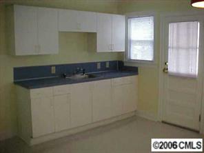 3716 Tuckaseegee Road, Unit A&B Charlotte, NC 28208 - Photo 3 of 8 a kitchen with a sink and cabinets