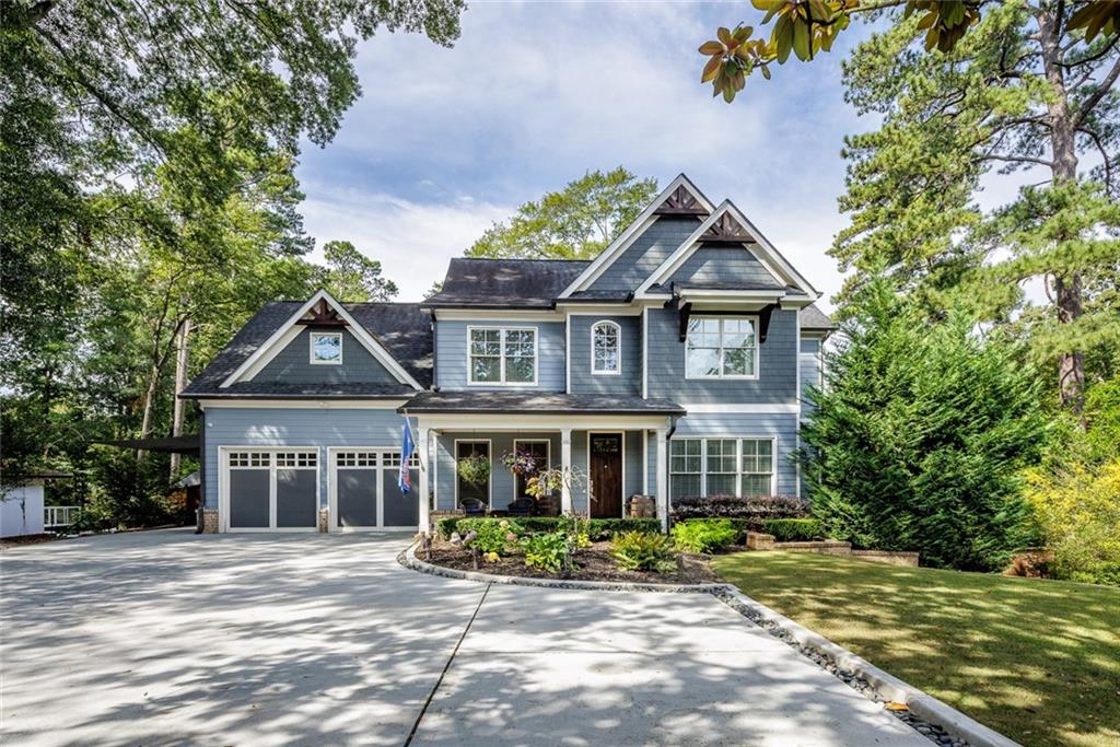 1948 East Roxboro Road Northeast Brookhaven, GA 30324 - Photo 1 of 1 a front view of a house with a garden