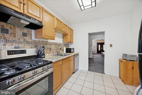 a kitchen with a stove and a refrigerator
