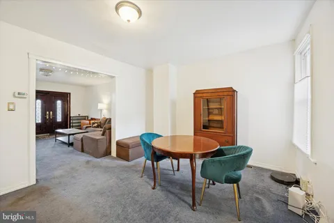 a living room with furniture and a dining table