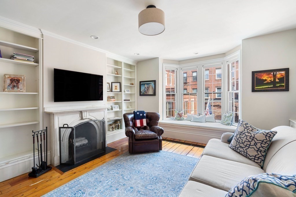 12 Cedar Street Boston, MA 02129 - Photo 13 of 23 a living room with furniture a flat screen tv and a fireplace