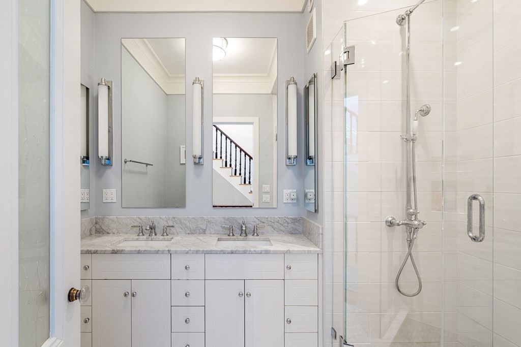 12 Cedar Street Boston, MA 02129 - Photo 16 of 23 a bathroom with a granite countertop sink shower and a mirror