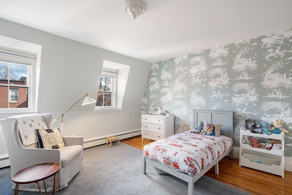 12 Cedar Street Boston, MA 02129 - Photo 18 of 23 a bedroom with a bed and dresser with wooden floor