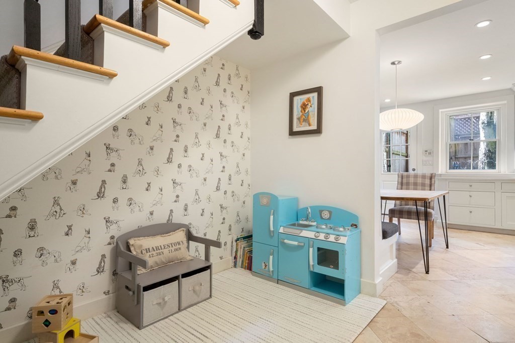 12 Cedar Street Boston, MA 02129 - Photo 9 of 23 a living room with a couch and a stove next to a window