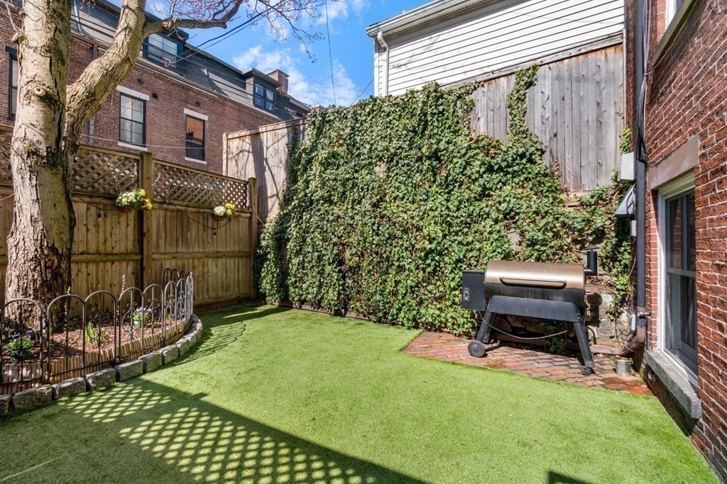12 Cedar Street Boston, MA 02129 - Photo 10 of 23 a backyard of a house with lots of green space