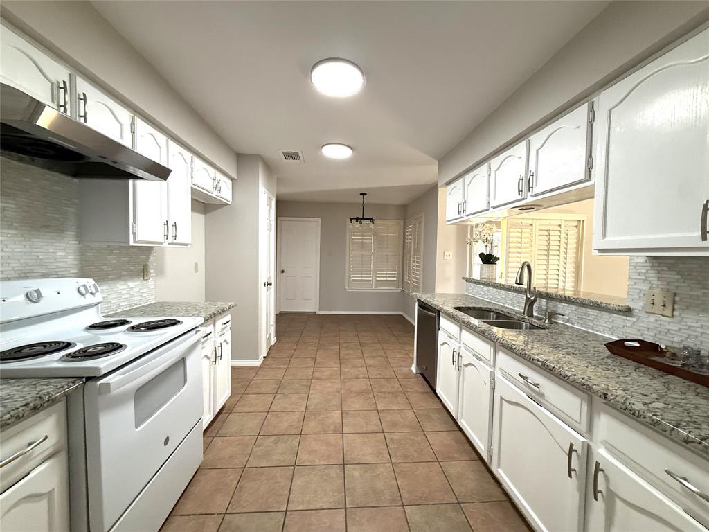 652 Harrison Drive Coppell, TX 75019 - Photo 11 of 26 a large kitchen with stainless steel appliances granite countertop a stove a sink and a refrigerator