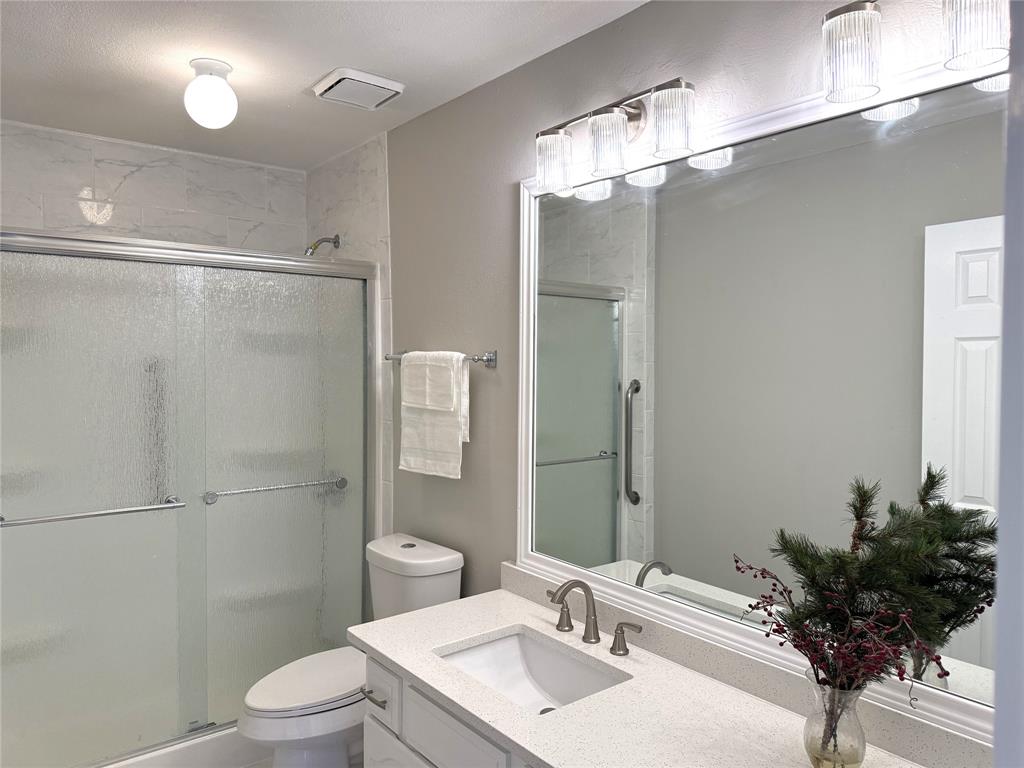 652 Harrison Drive Coppell, TX 75019 - Photo 15 of 26 a bathroom with a sink toilet and shower