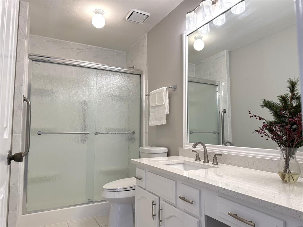 652 Harrison Drive Coppell, TX 75019 - Photo 16 of 26 a bathroom with a sink toilet and shower