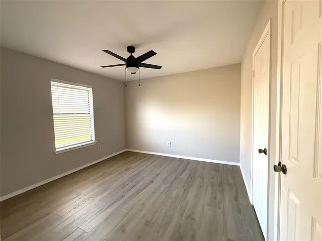 wooden floor in an empty room with a window