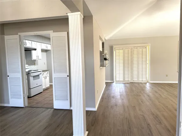 a view of a kitchen cabinets wooden floor and a kitchen