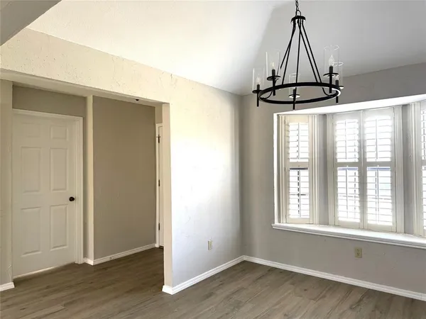 a view of a room with wooden floor and windows