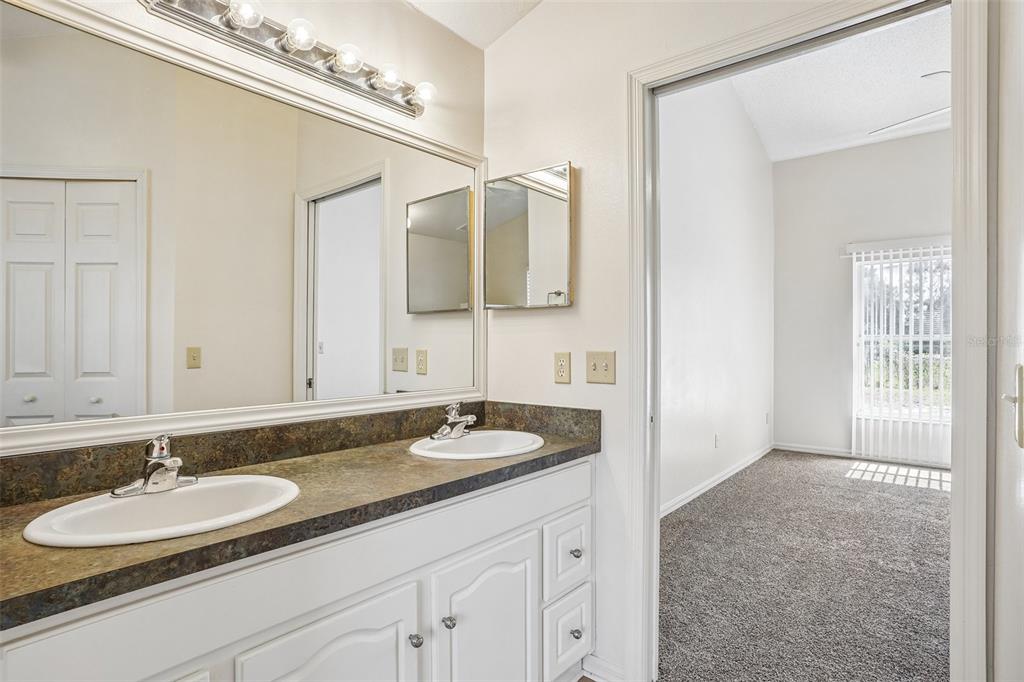 2596 Alclobe Circle Ocoee, FL 34761 - Photo 38 of 70 a bathroom with a granite countertop sink and a mirror