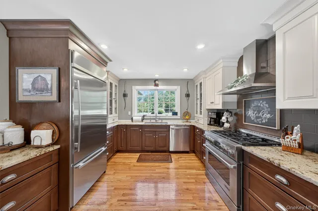 a large kitchen with stainless steel appliances granite countertop a stove and a sink