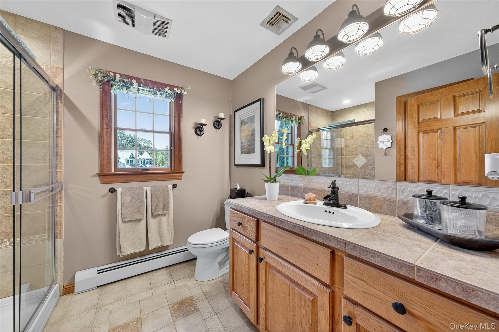 91 Distillery Road Warwick, NY 10990 - Photo 20 of 49 a bathroom with a double vanity sink a toilet and a mirror