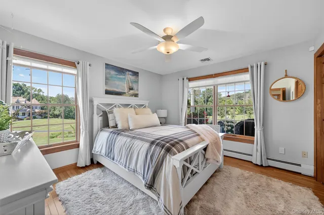 a bedroom with a bed and a large window