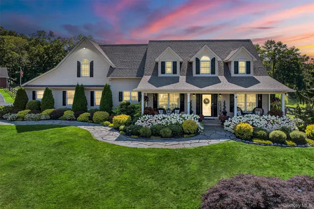 a front view of house with yard and green space