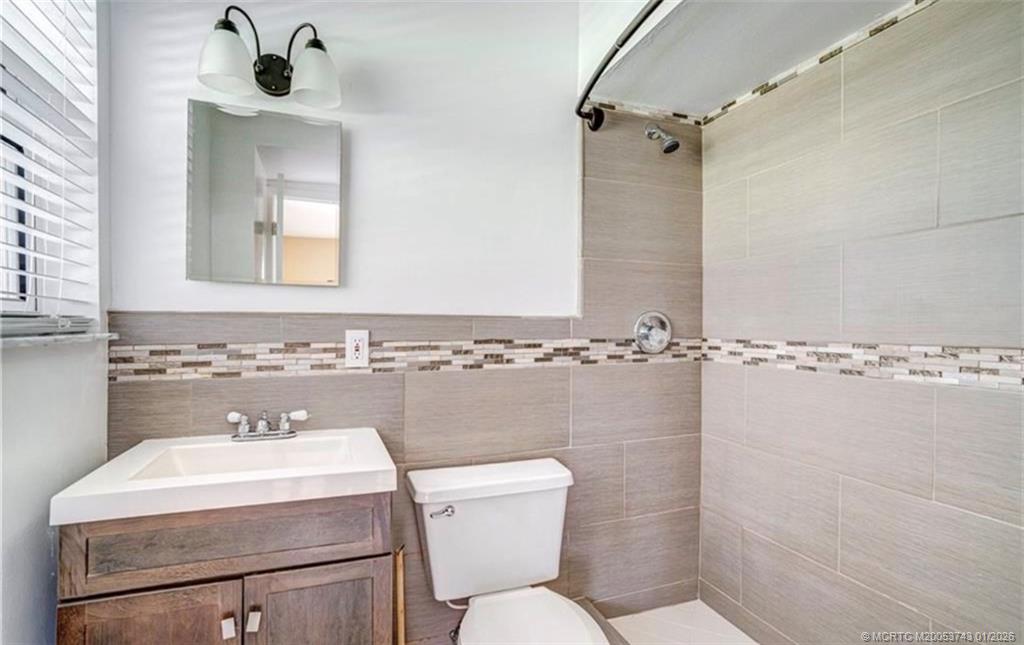 820 Northwest 10th Terrace Stuart, FL 34994 - Photo 12 of 21 a bathroom with a sink a toilet and shower