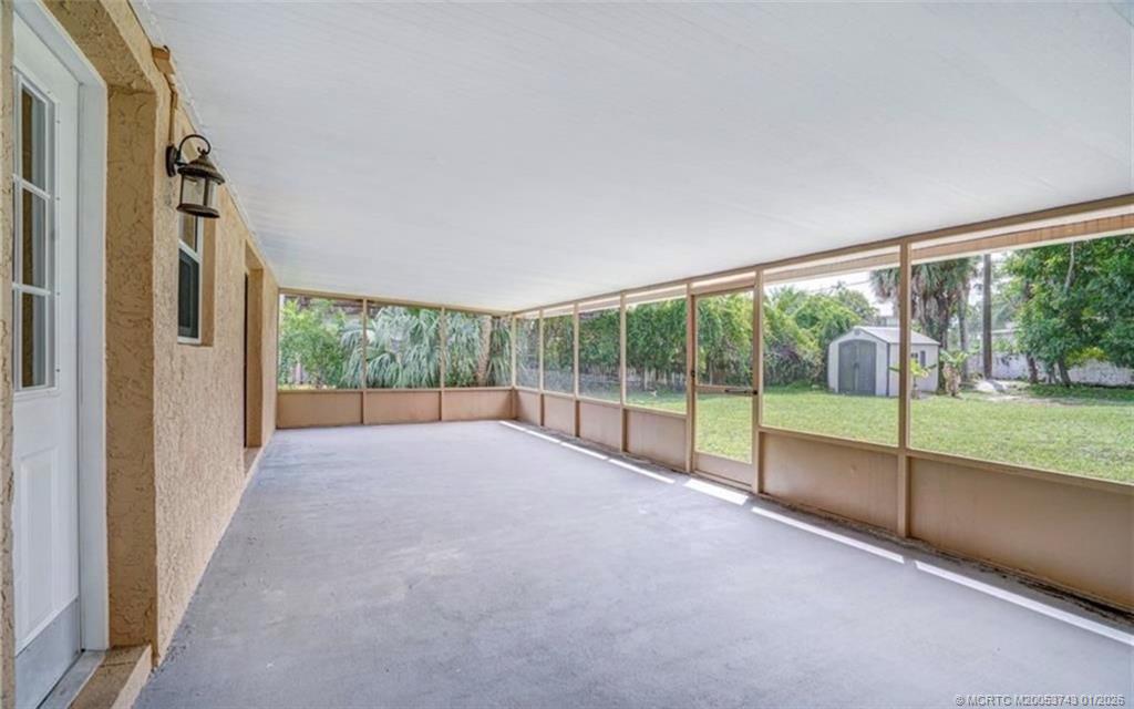 820 Northwest 10th Terrace Stuart, FL 34994 - Photo 18 of 21 a view of an empty room with wooden floor and a fireplace