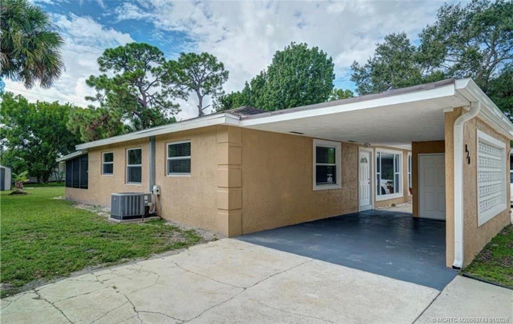 820 Northwest 10th Terrace Stuart, FL 34994 - Photo 19 of 21 a view of a house with a yard